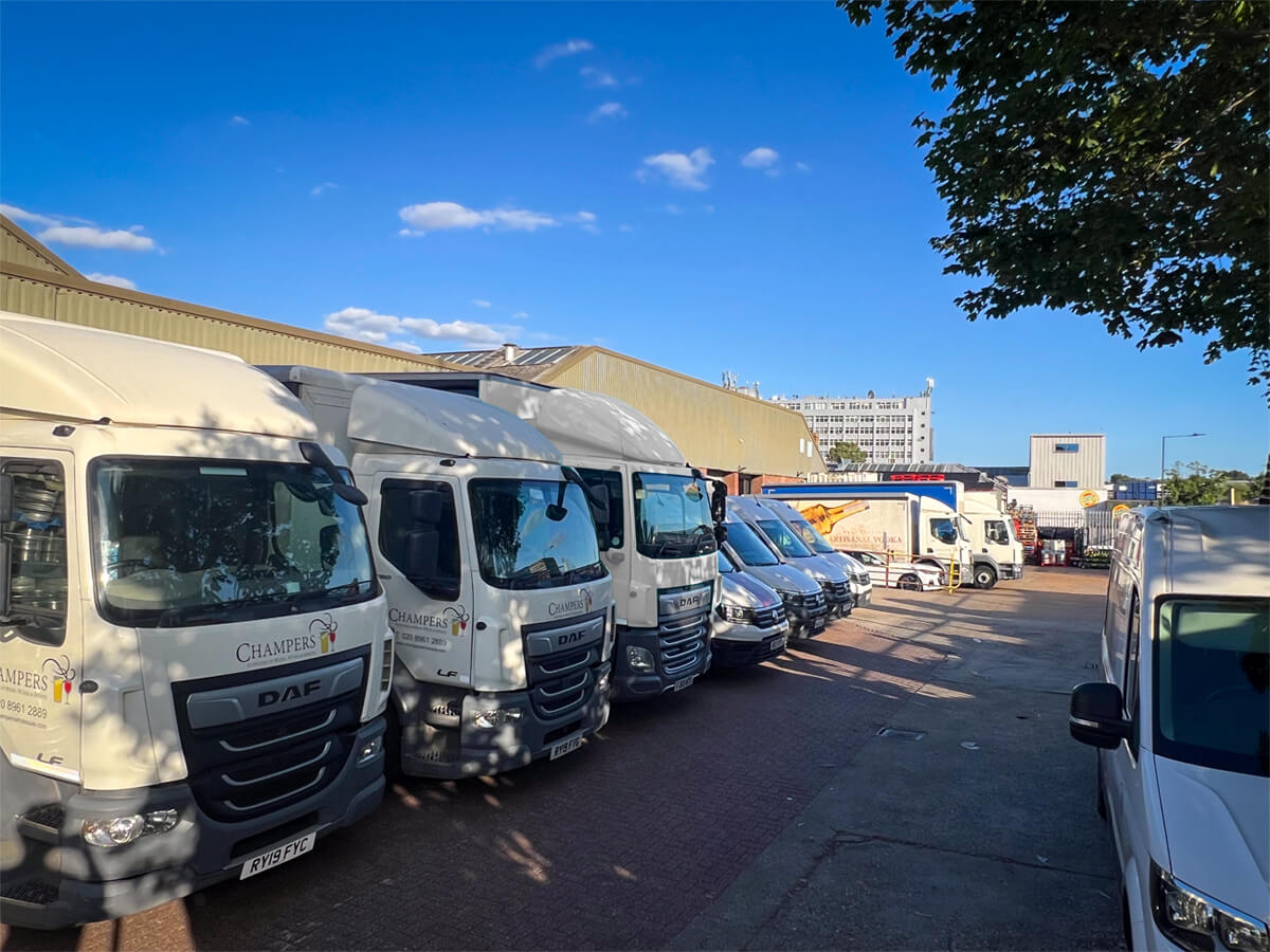 Parcked white delivery lories and vans fleet - champers drinks