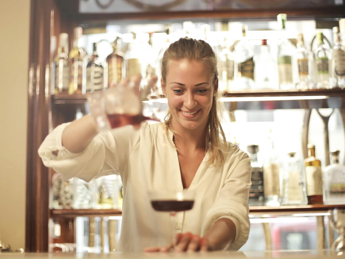 a women pouring wine - Champers Drinks