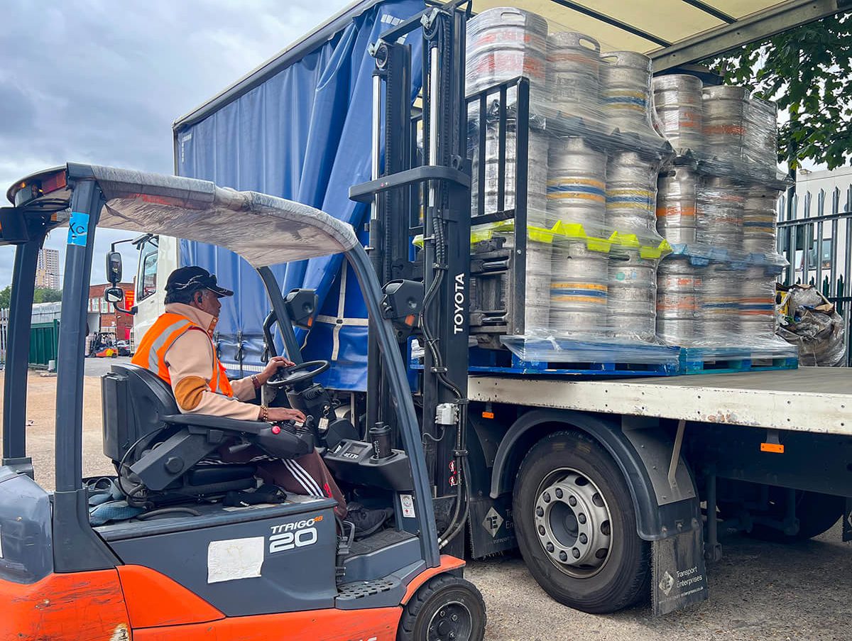 forklift loading kegs to a lorie - Champers Drinks