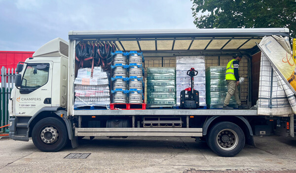 Parcked white delivery lorie being loaded - champers drinks